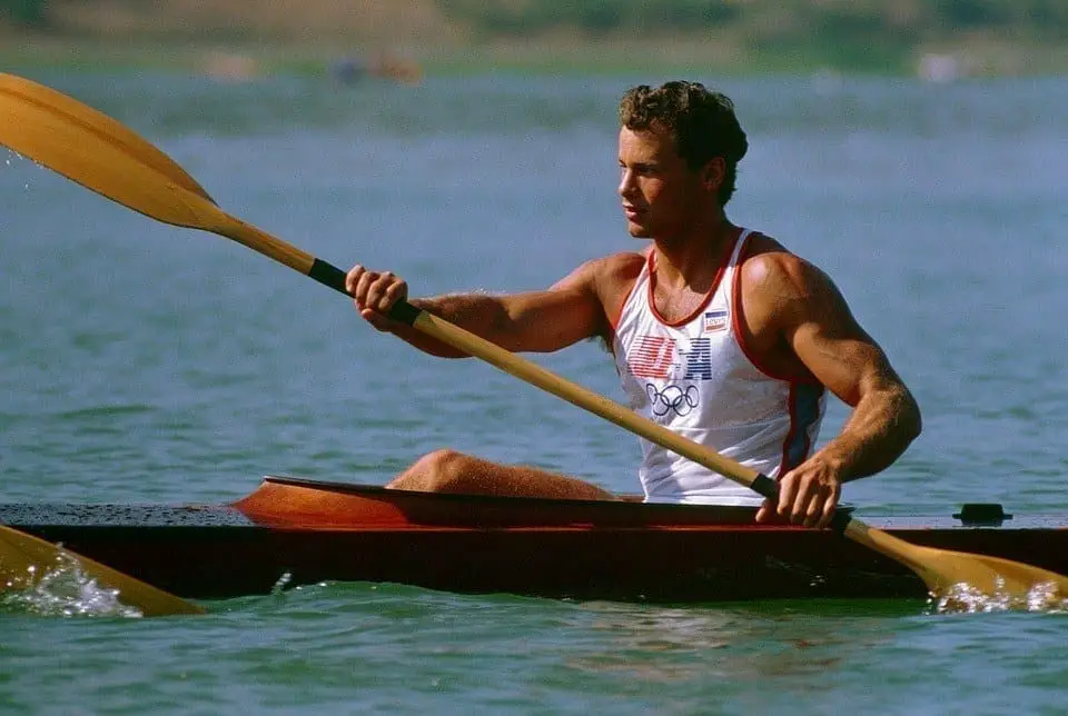 a man kayaking in a lake