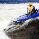 a man kayaking in rapids