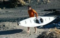 a man carriying a kayak