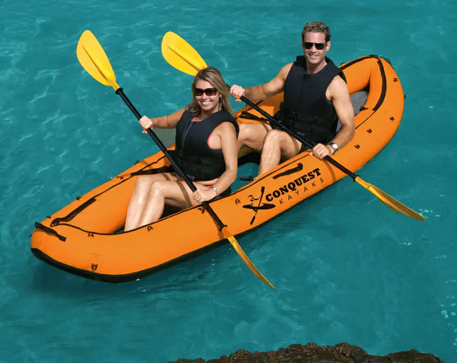 Two people in an inflatable kayak.