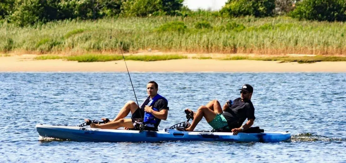 two persons pedaling a kayak