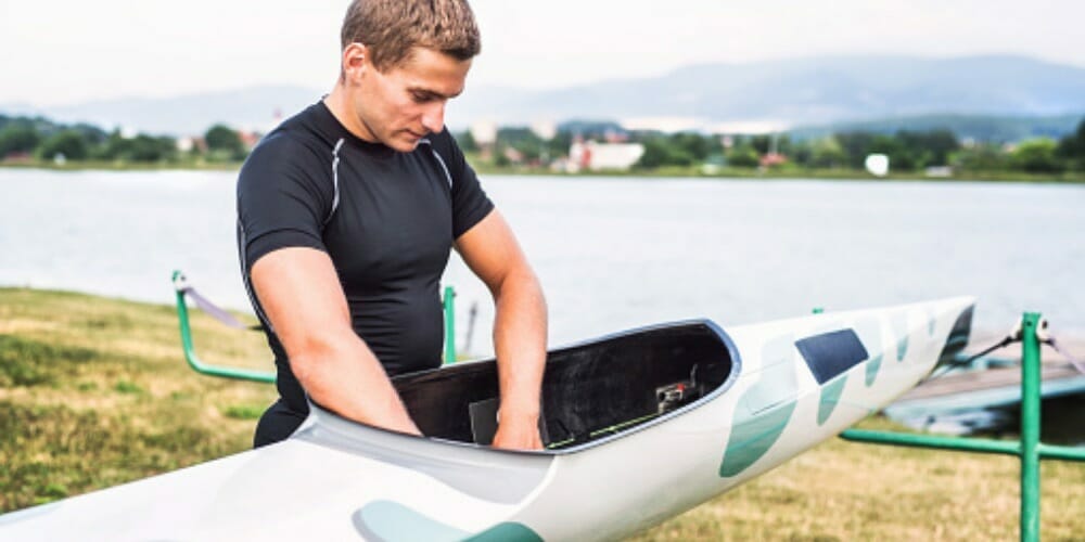 man cleaning his kayak