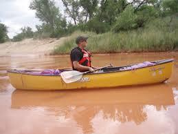 a man in a yellow canoe