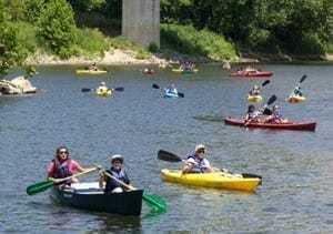 multiple kayaks and canoes