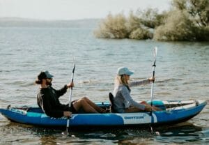 Two people in a kayak on a lake.