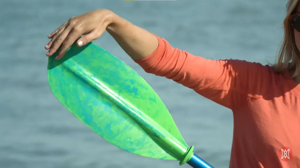 a girl holding her paddle