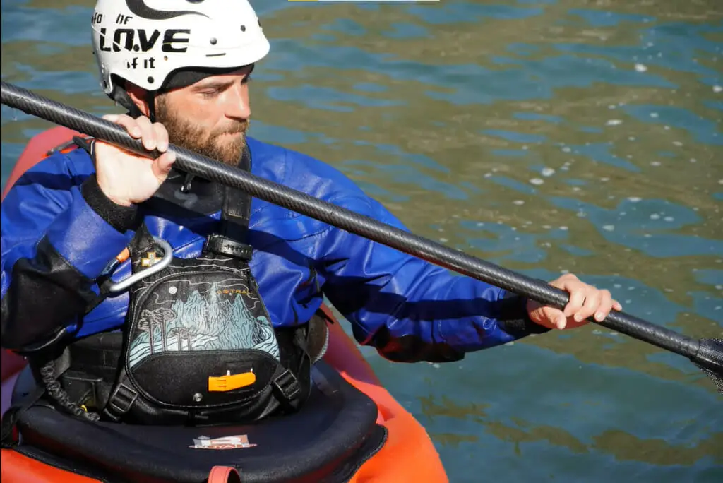 man paddling his kayak