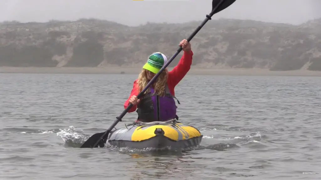 woman smiling while kayaking